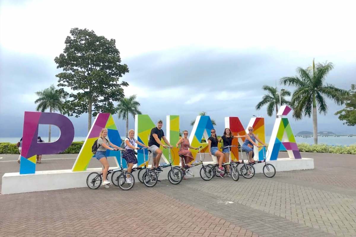 Panama City Bike Tour sightseeing Bike Tour guests on Panama sign Avenida Balboa