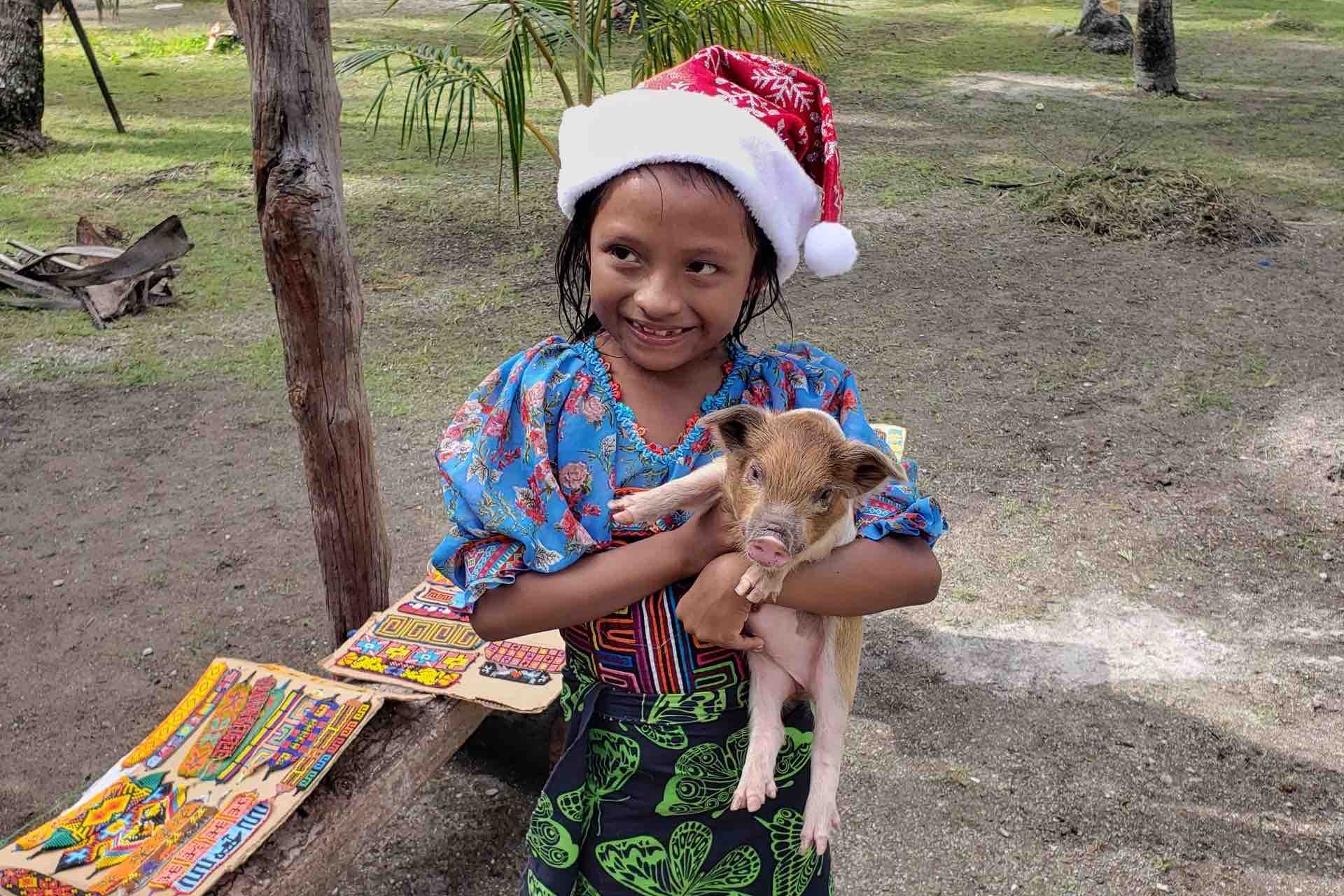 San Blas islands Kuna girl holding ocean pig