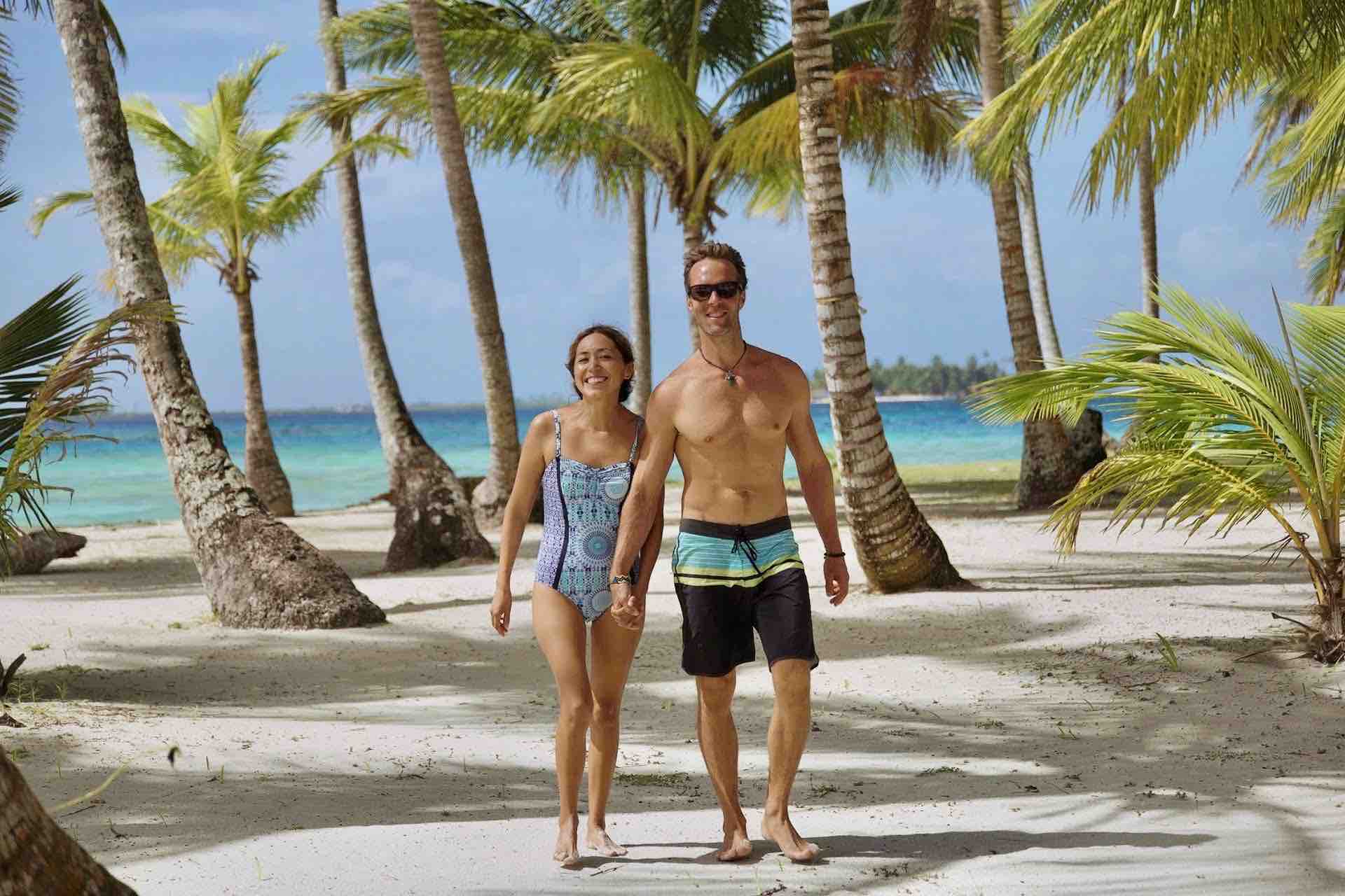 San Blas islands happy couple walking on beach palm trees panama tour