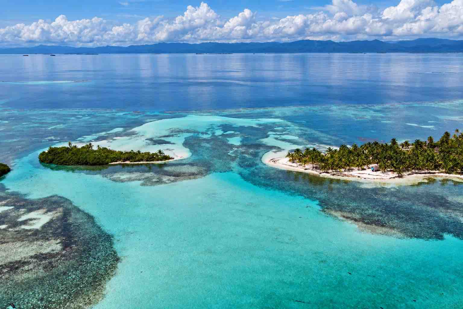 San Blas Islands Panama Two palm-covered San Blas islands separated by clear turquoise shallows