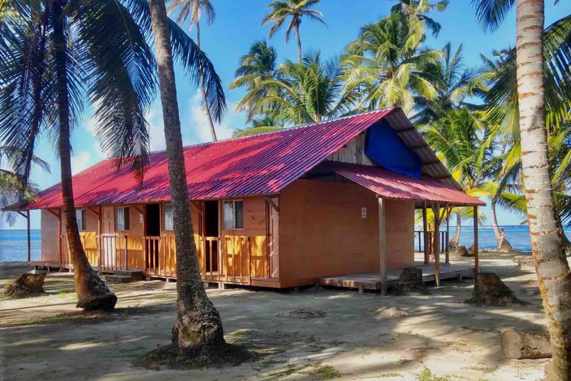 San Blas Isla Yansailadup island private rooms building palm trees beach
