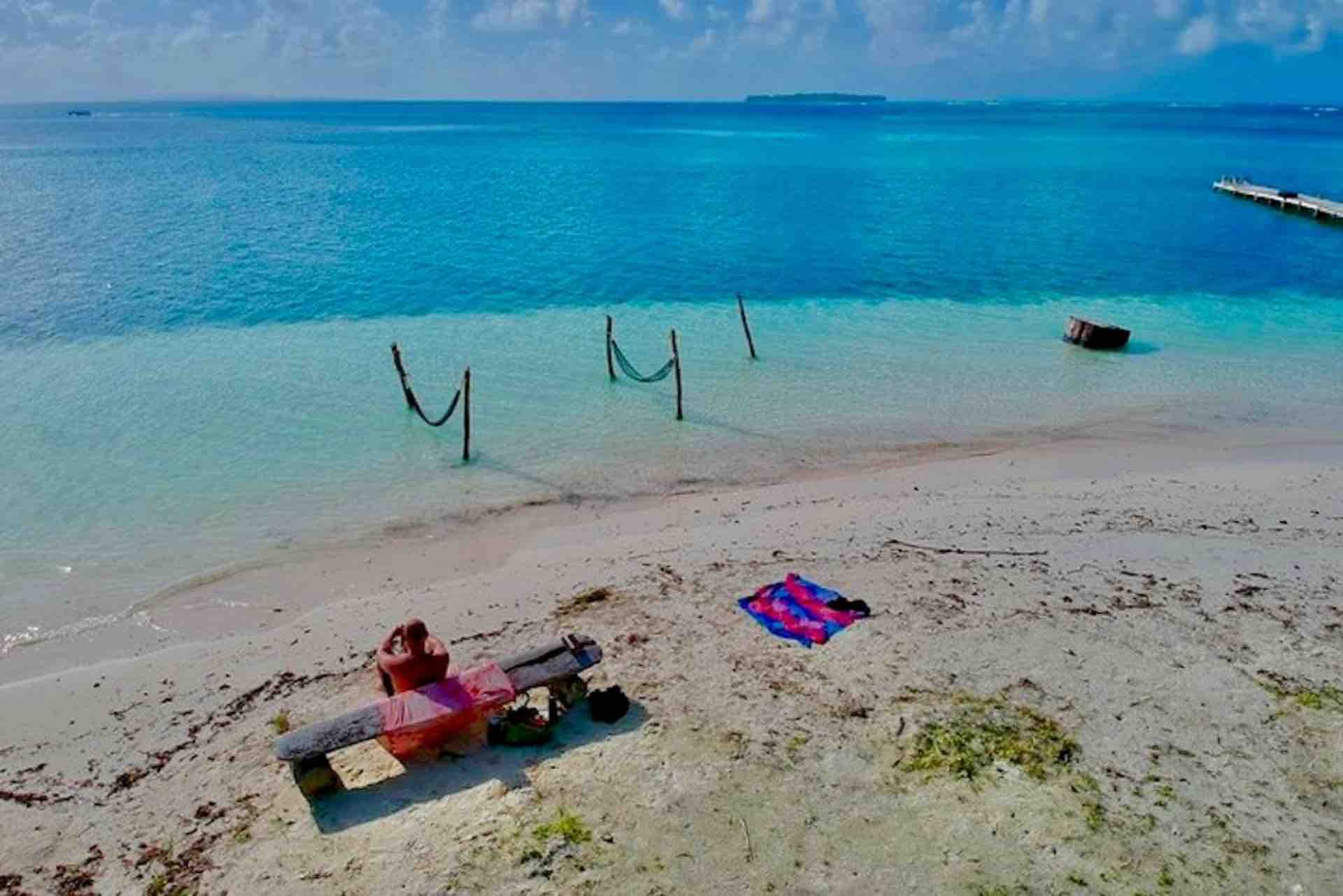 San Blas Isla Yansailadup man on white sand beach drone