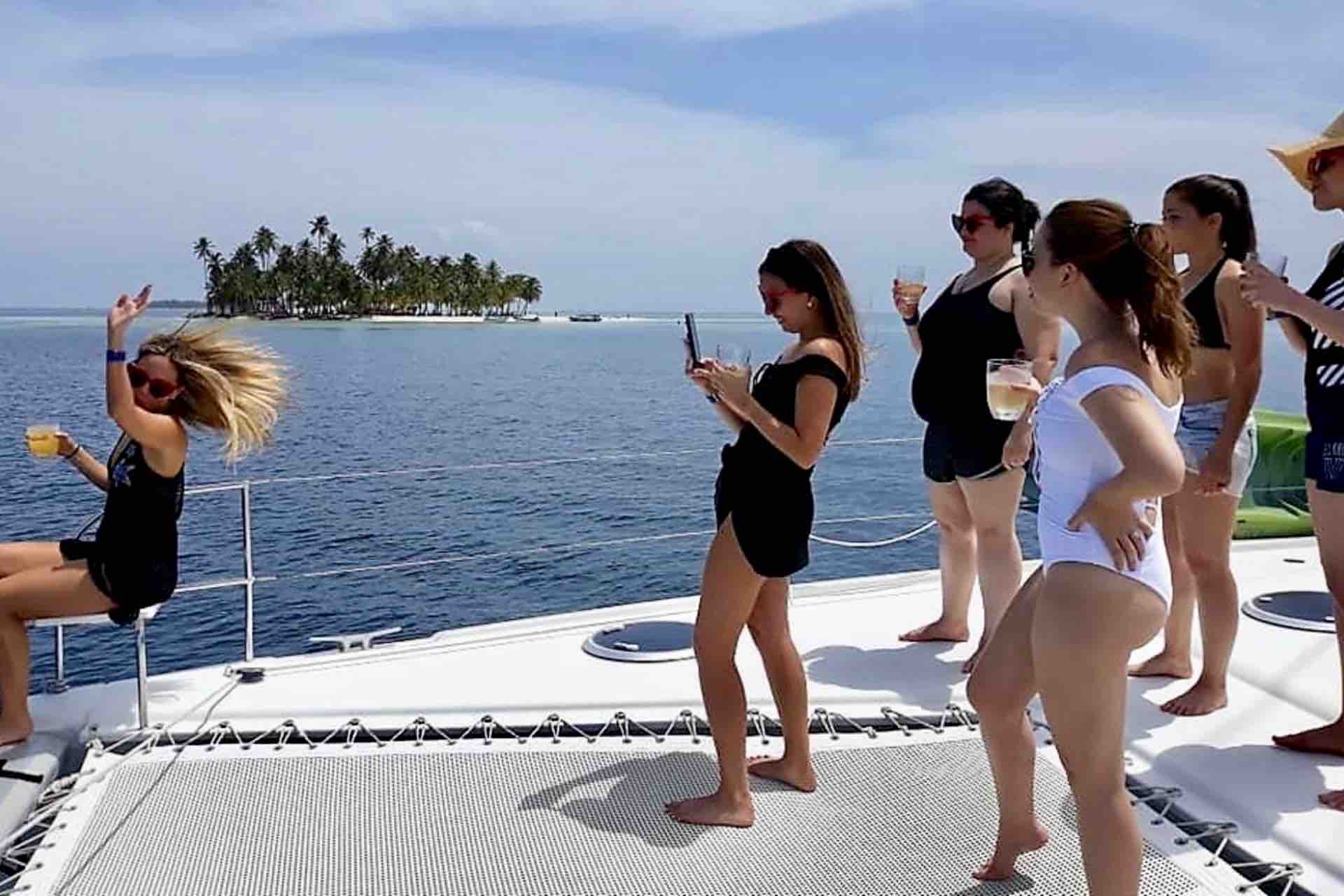 Zenith catamaran guests standing on net