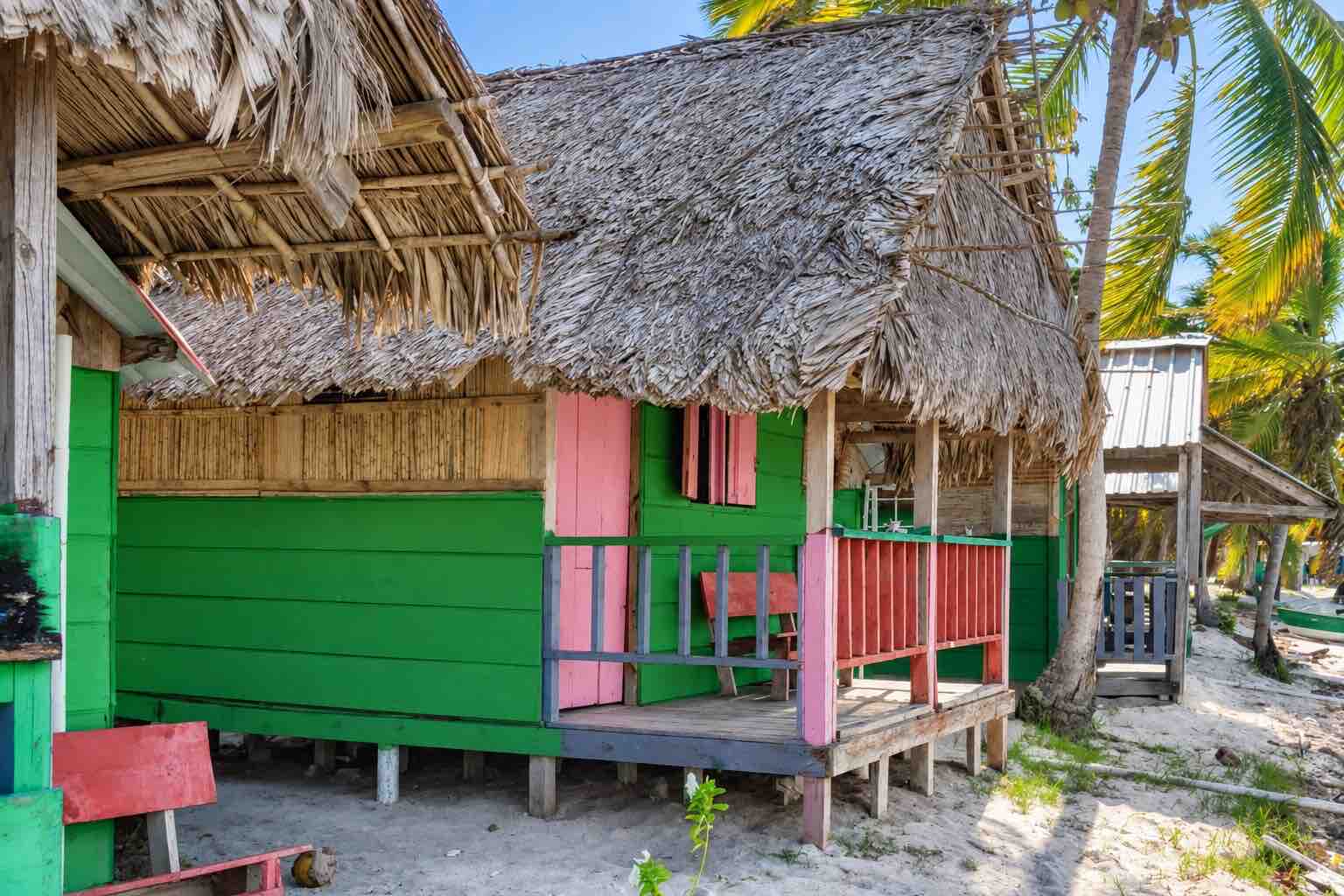 Green and pink rustic private cabin on Isla Diablo San Blas