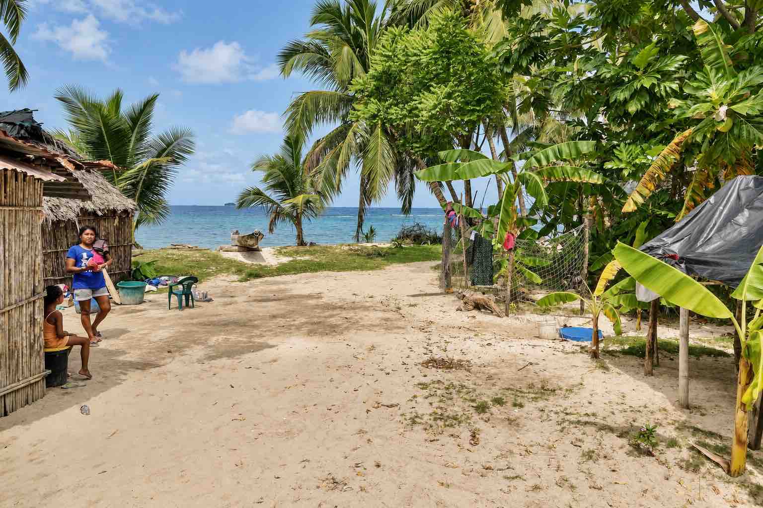 Sandy village path leading toward the beach on Isla Narasgandup