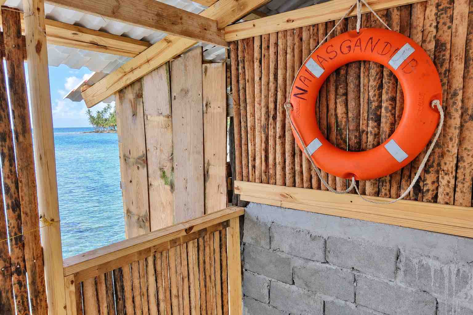 Restaurant window and life ring overlooking the sea on Isla Narasgandup