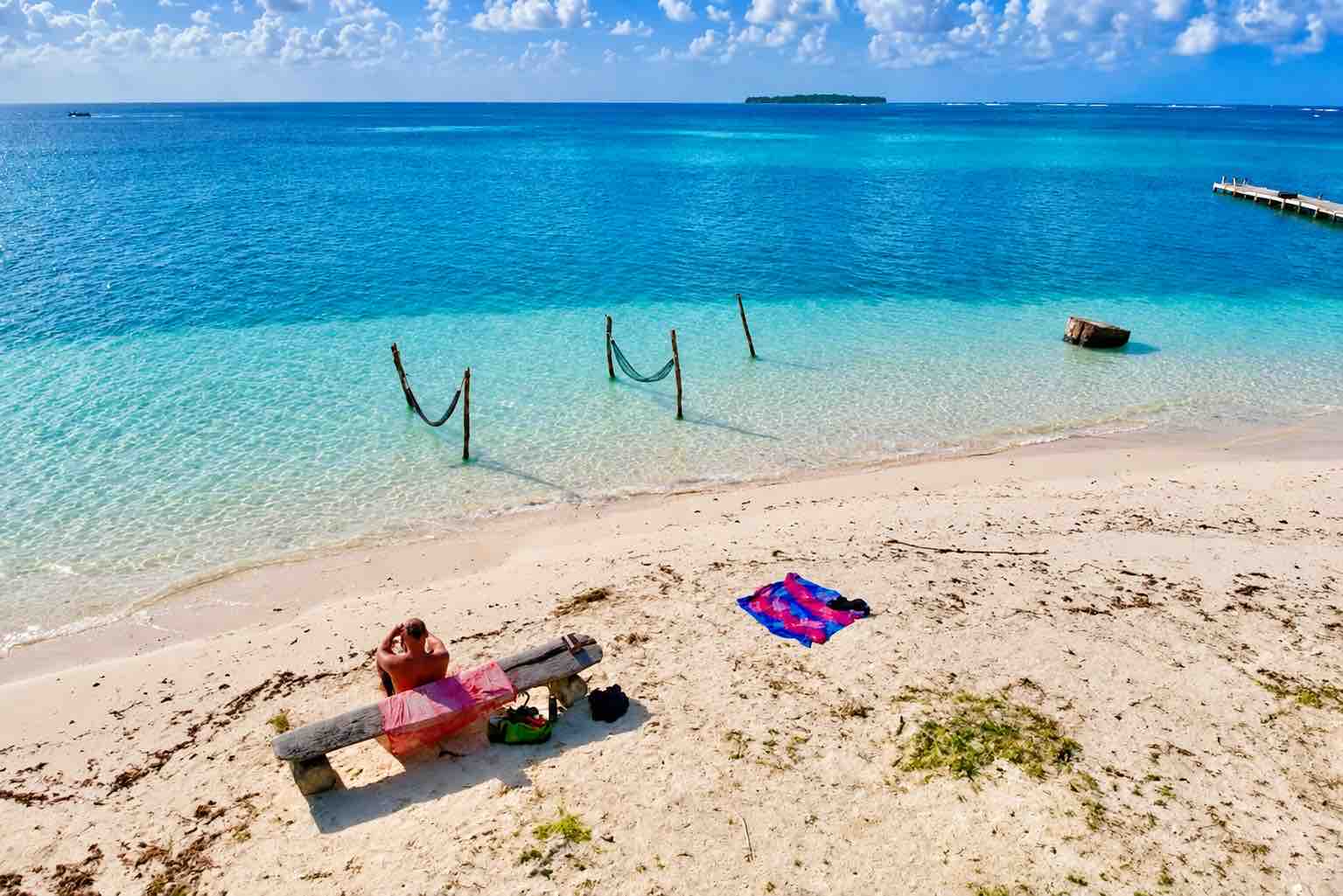 White sand beach and turquoise water viewed from above