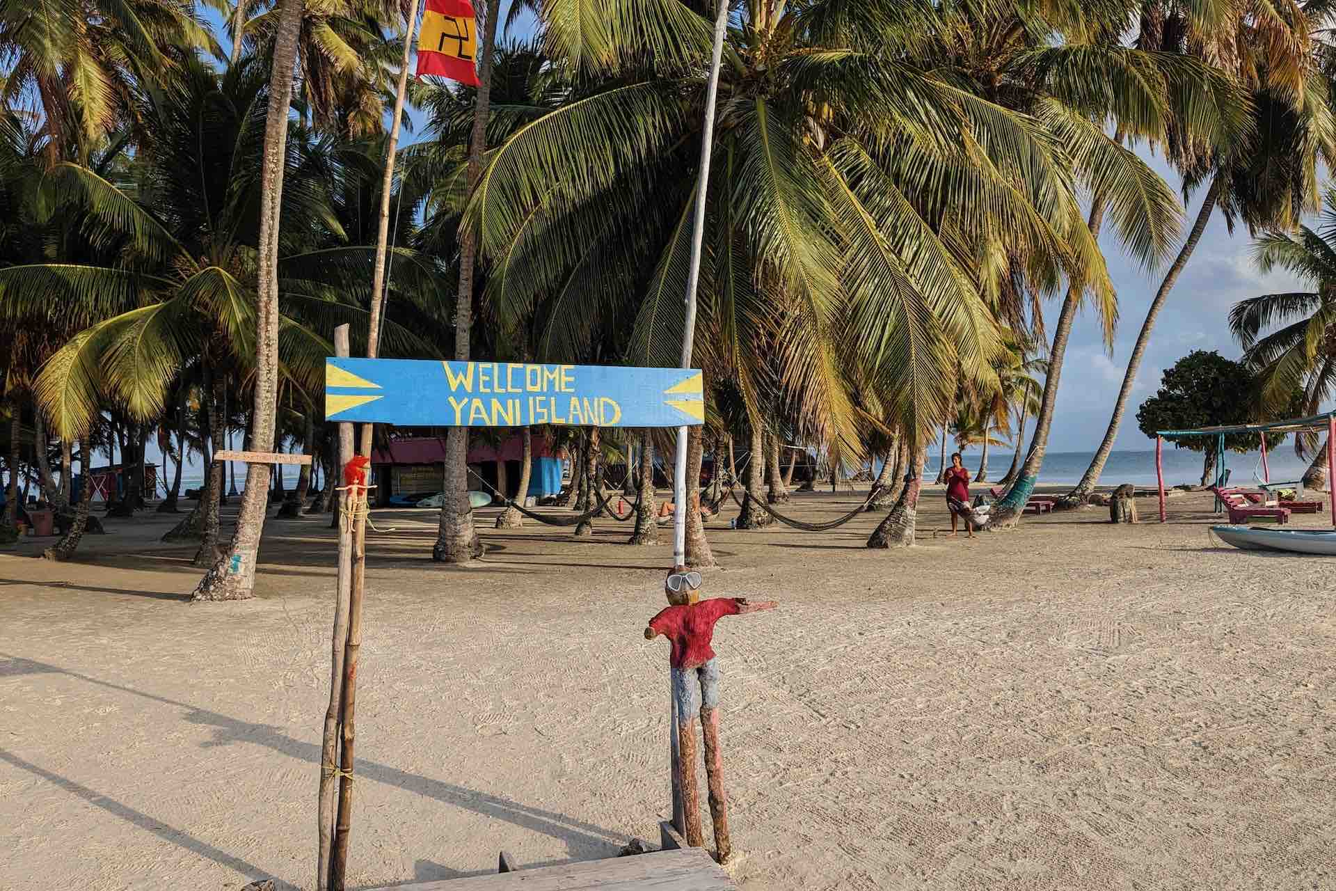 Welcome sign among palm trees on the island