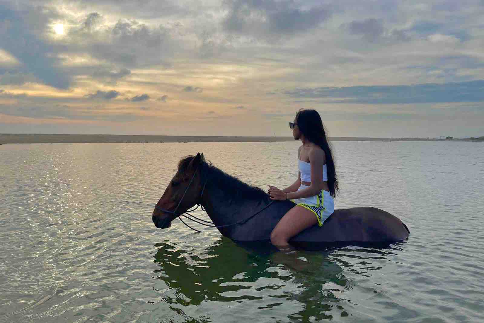 Beach Horseback riding Woman inside Lagoon