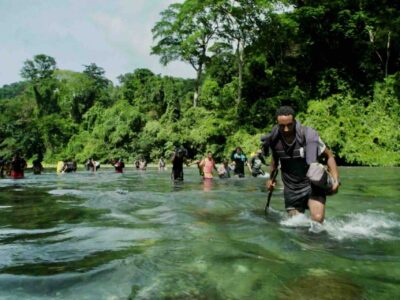 Darien Jungle tour guests hiking in river