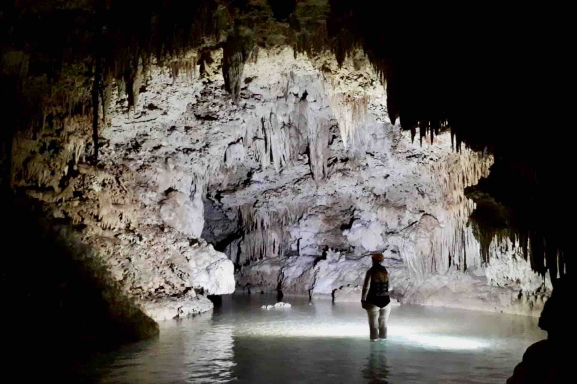 Cenote Riviera Maya Mexico Cenote tour guest looking at stalactites