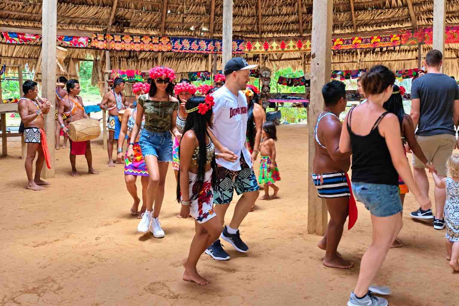 Guests join the village dance and music.