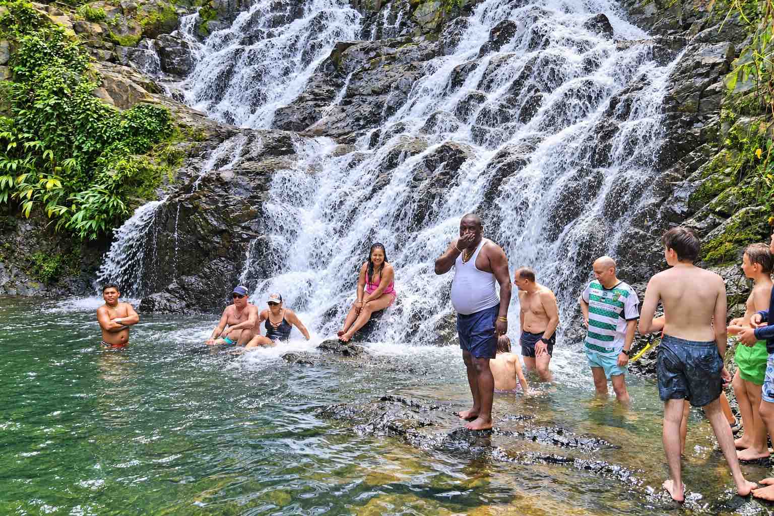 Embera Village Tour – Rainforest Waterfall Guests swimming at a rainforest waterfall during an Embera village tour in Panama