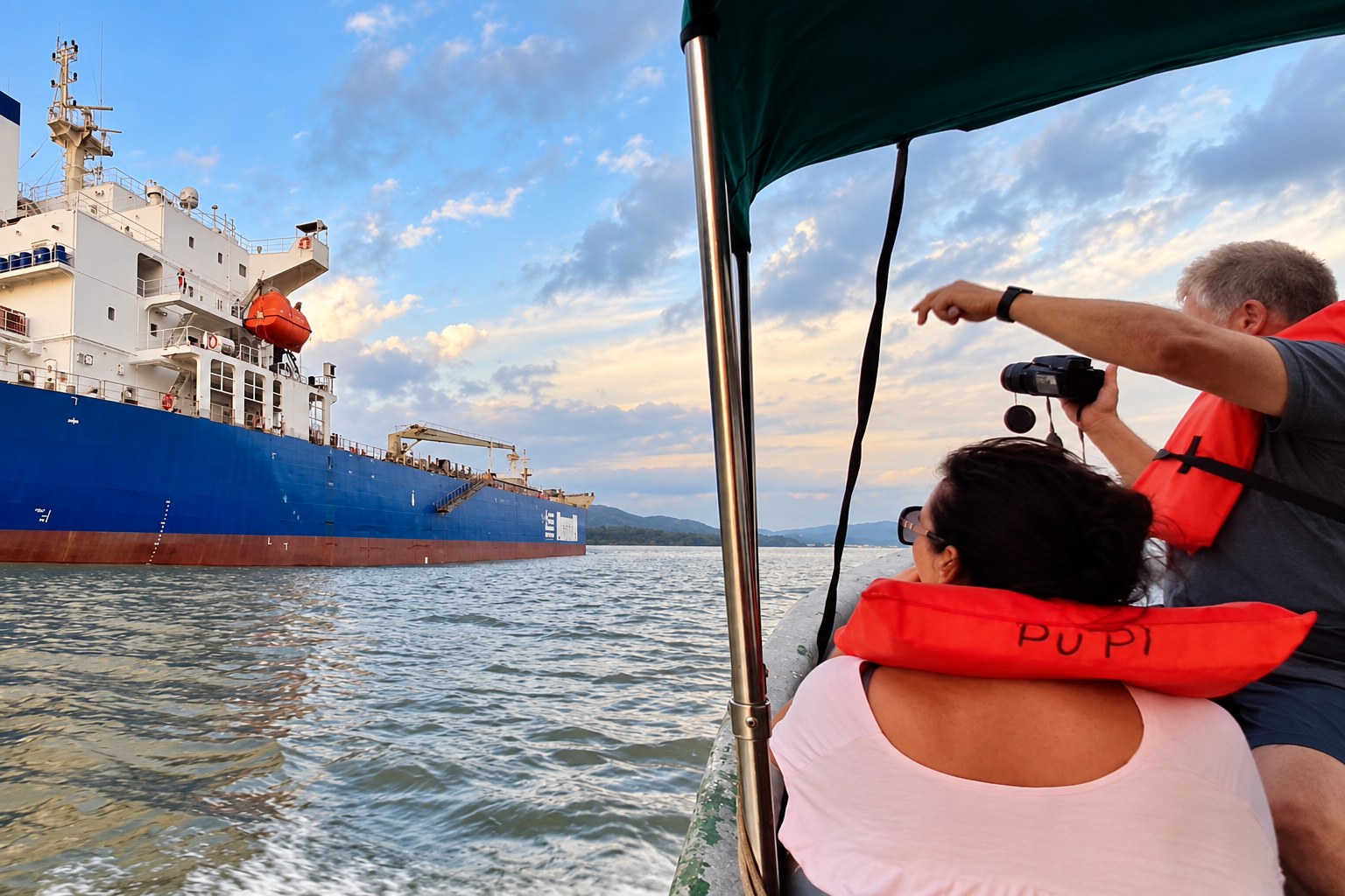 Monkey Island Boat Tour Panama – Cargo Ship Photography Monkey Island boat tour Panama: Visitors photographing a blue cargo ship from their boat