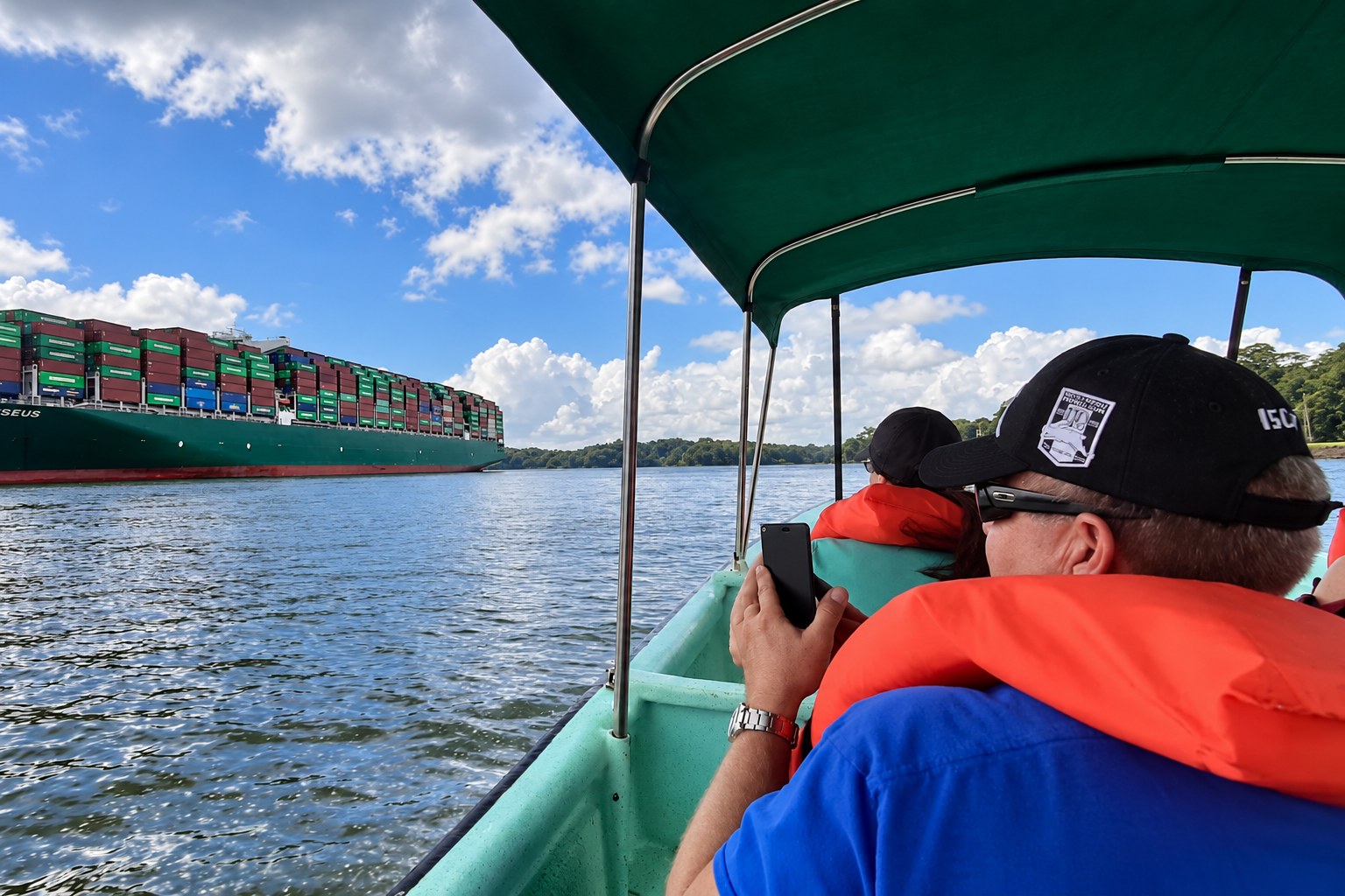 Monkey Island boat tour Panama: Guests watching a container ship from a covered boat
