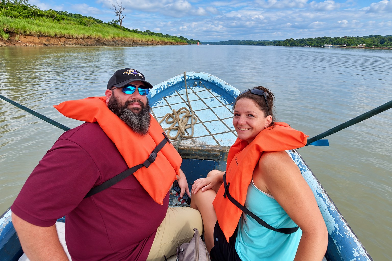 Monkey Island boat tour Panama: Couple wearing orange life jackets at the bow of a boat