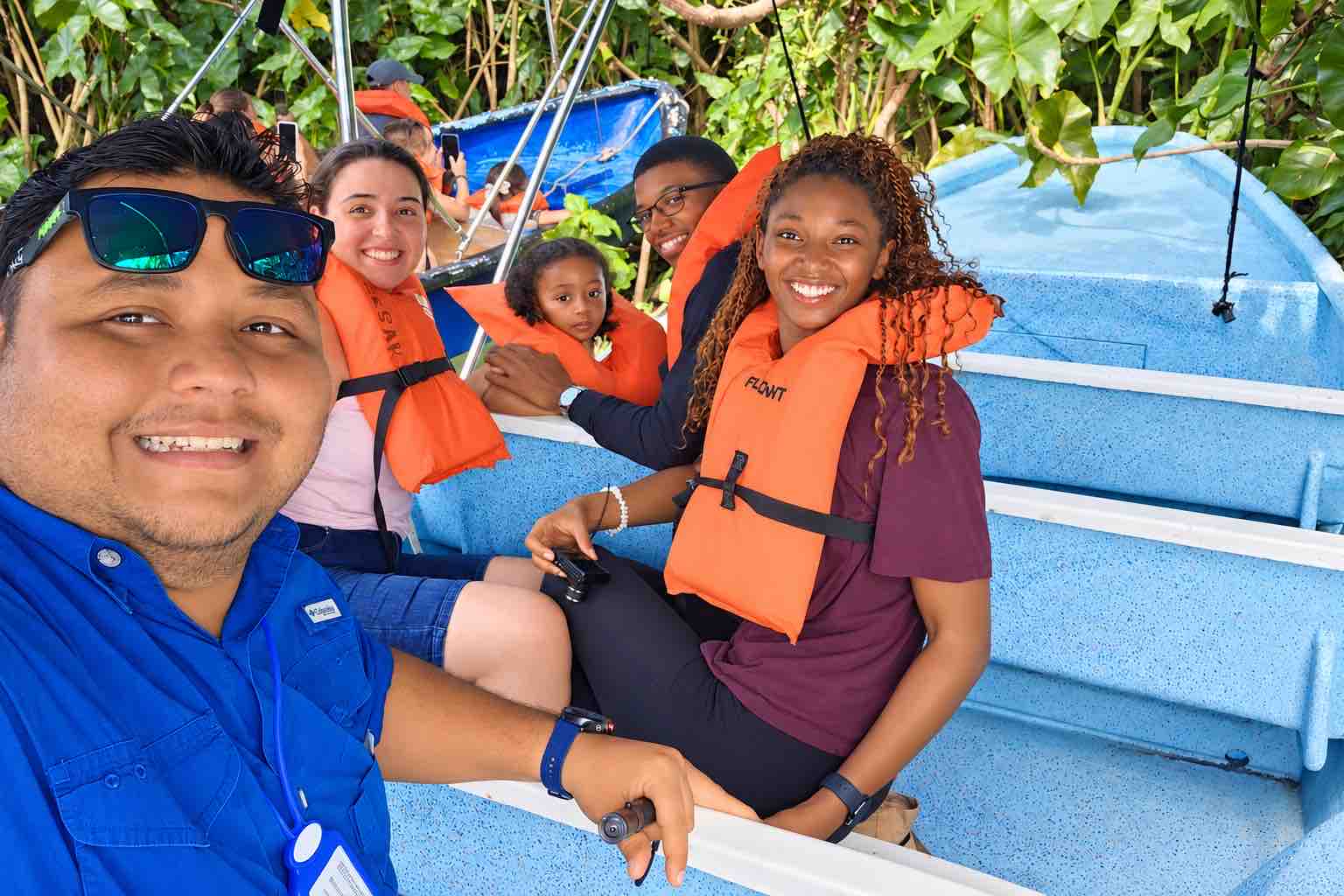 Family and guide posing aboard a Monkey Island boat tour Panama
