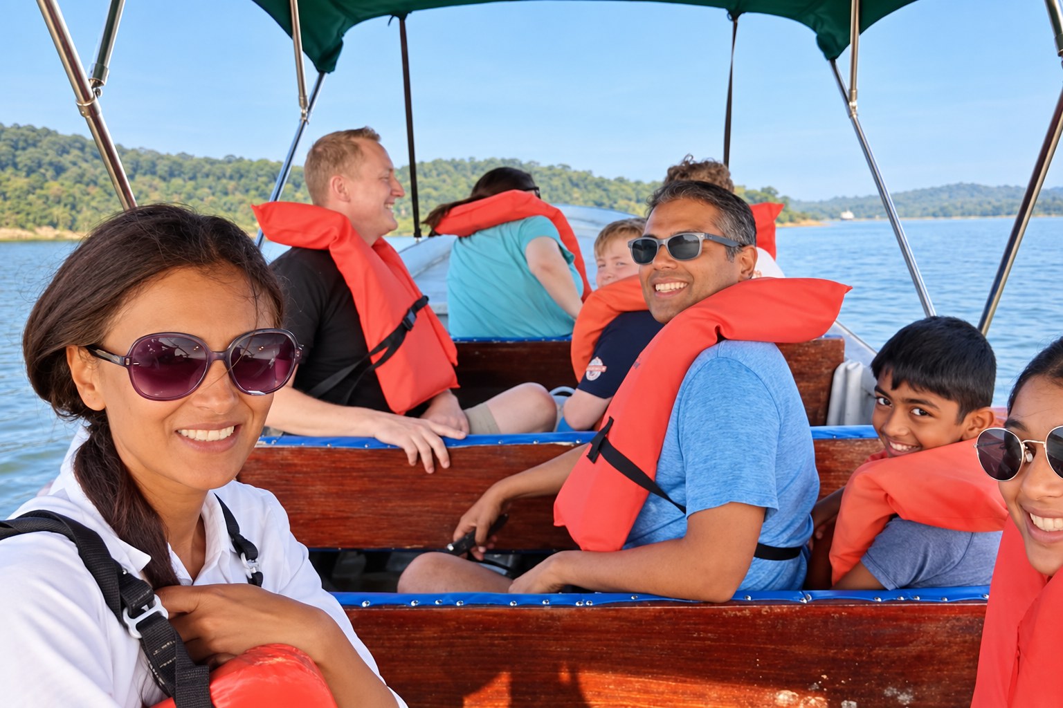 Monkey Island boat tour Panama: Adults and children wearing orange life jackets aboard a covered boat