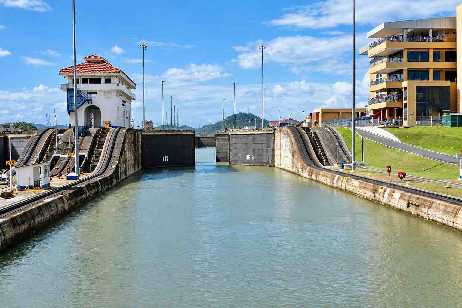 Panama Canal and City Tour: water-filled Panama Canal lock chamber with gates and control buildings.