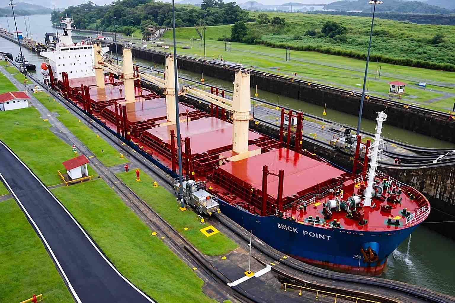 Panama Canal and City Tour: a cargo ship inside a Panama Canal lock chamber.