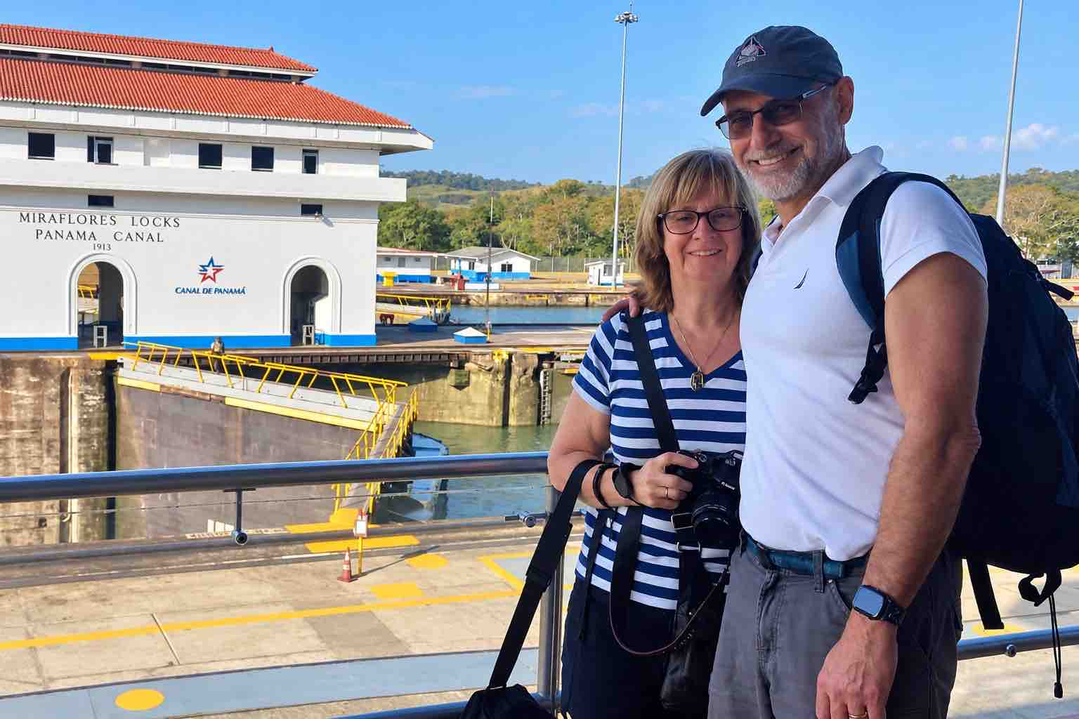 Panama Canal and City Tour: a couple posing beside the viewing railing at Miraflores Locks.