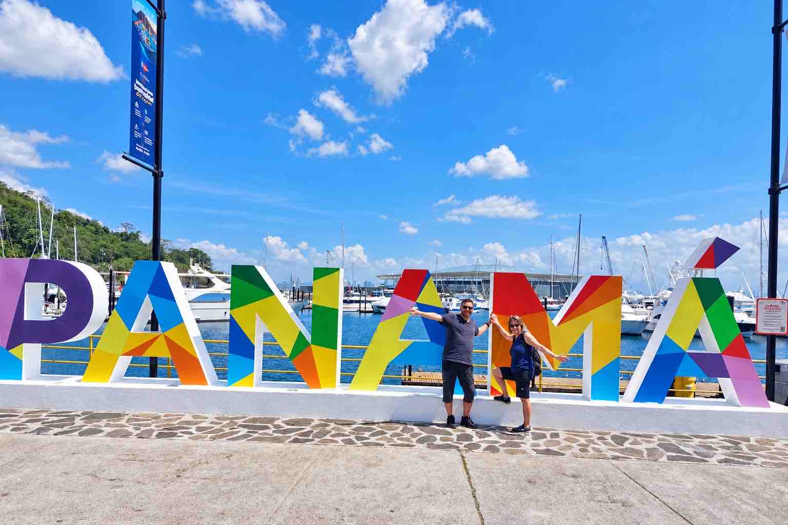 Panama Canal and City Tour: a couple posing beside the colorful Panama sign.
