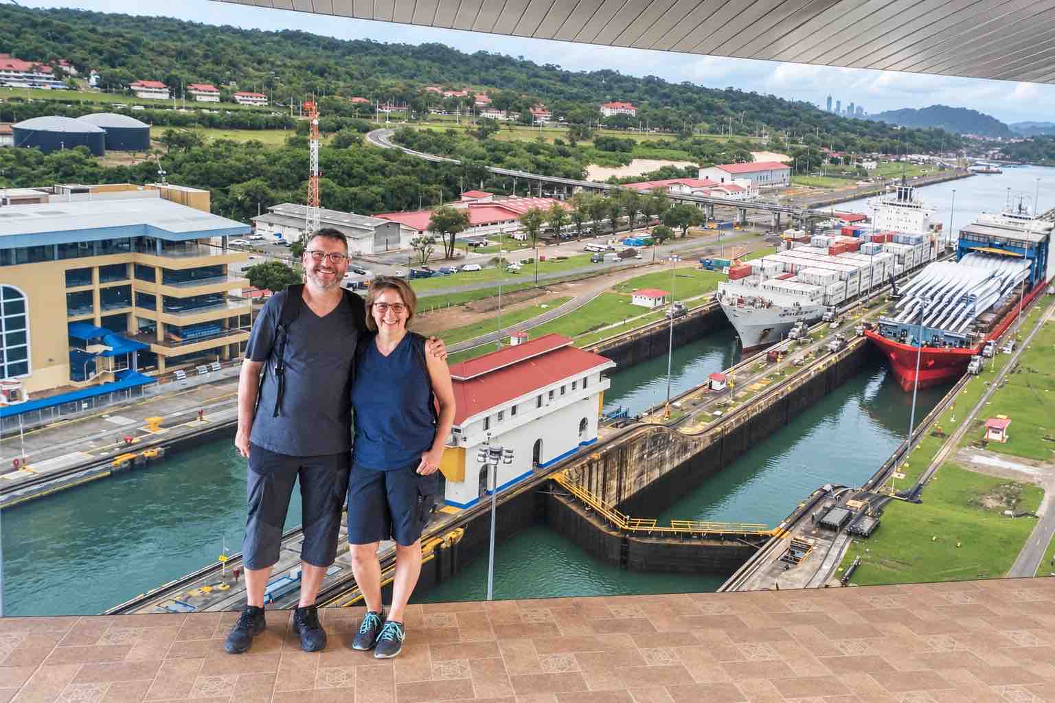 Panama Canal and City Tour: a couple posing in front of a photographic backdrop of Miraflores Locks.