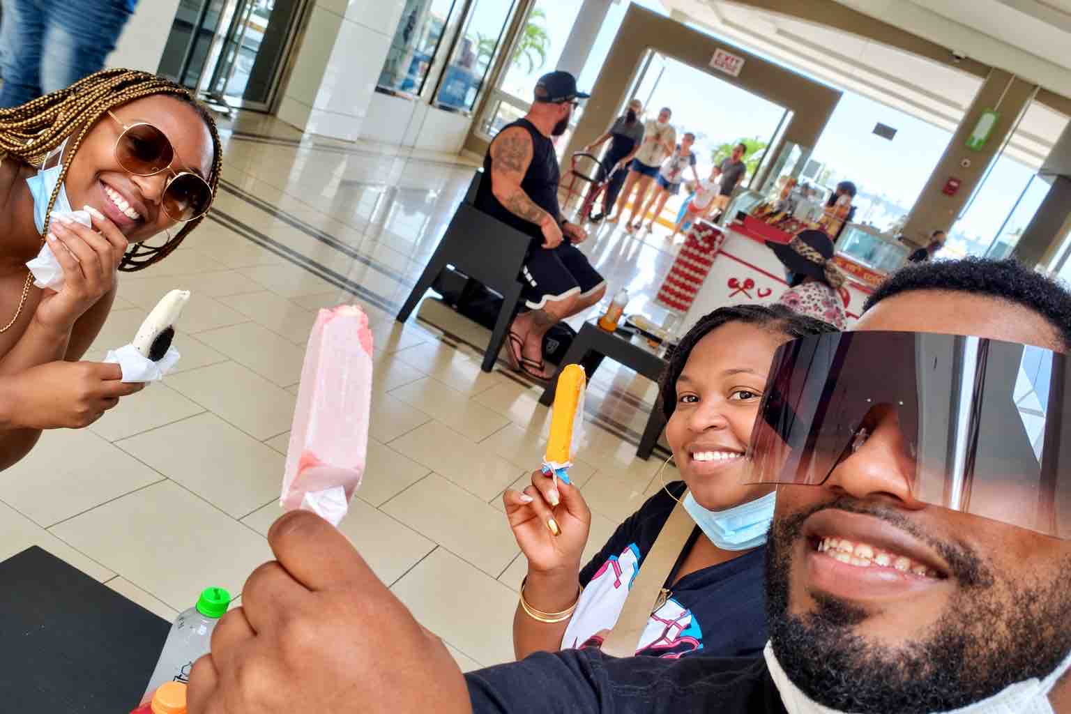 Panama Canal and City Tour: guests and a guide posing for a selfie while holding frozen treats.