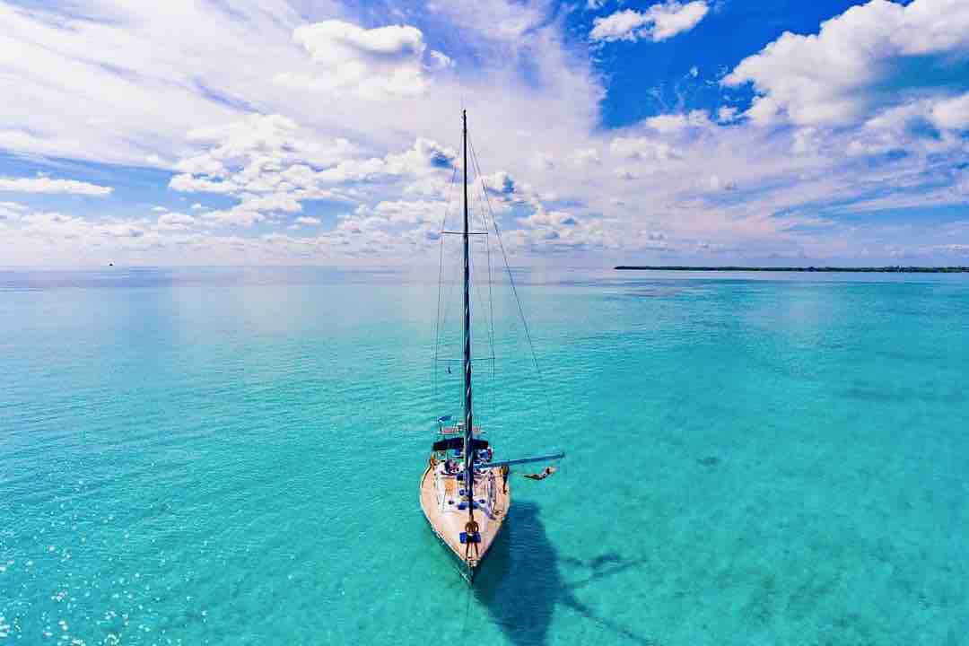 Maverick sailboat from front in turquoise ocean water