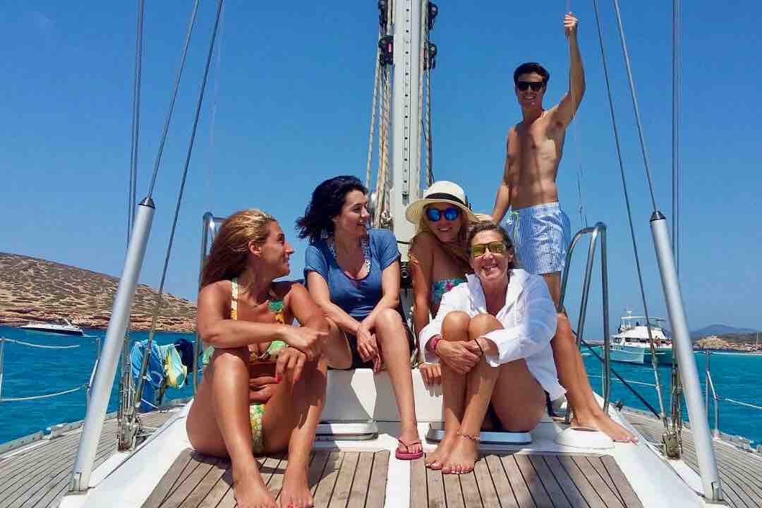 Maverick guests on sailboat deck in the sun