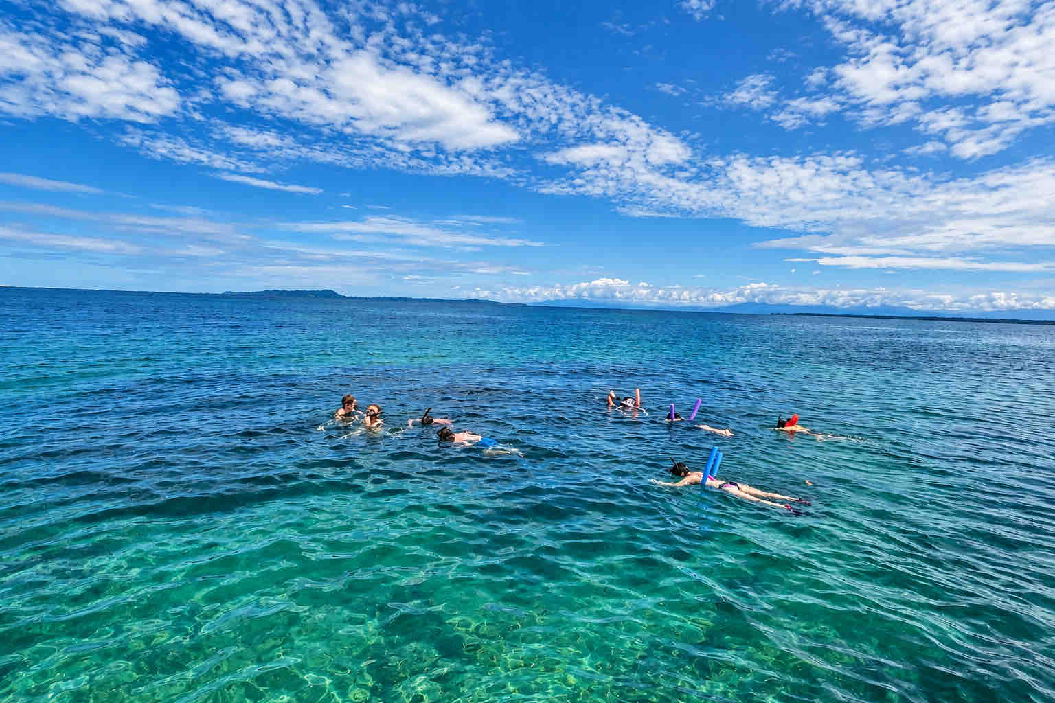 Cayo Coral Snorkeling – Bocas del Toro Travelers snorkeling with flotation noodles during a Zapatilla Island Tour in Bocas del Toro
