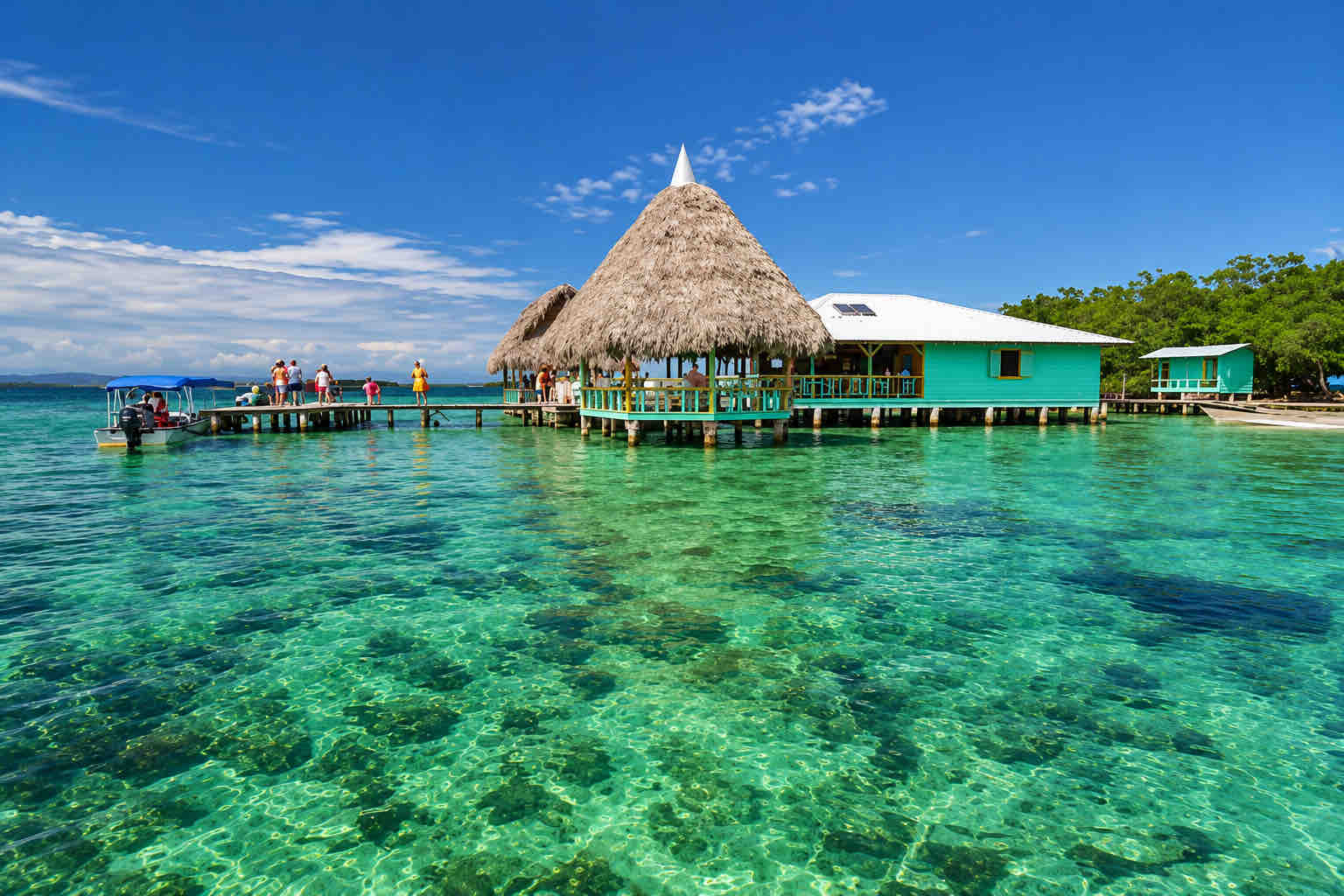 Cayo Coral – Bocas del Toro Panama Thatched overwater building and turquoise waterfront structures at Cayo Coral, Bocas del Toro