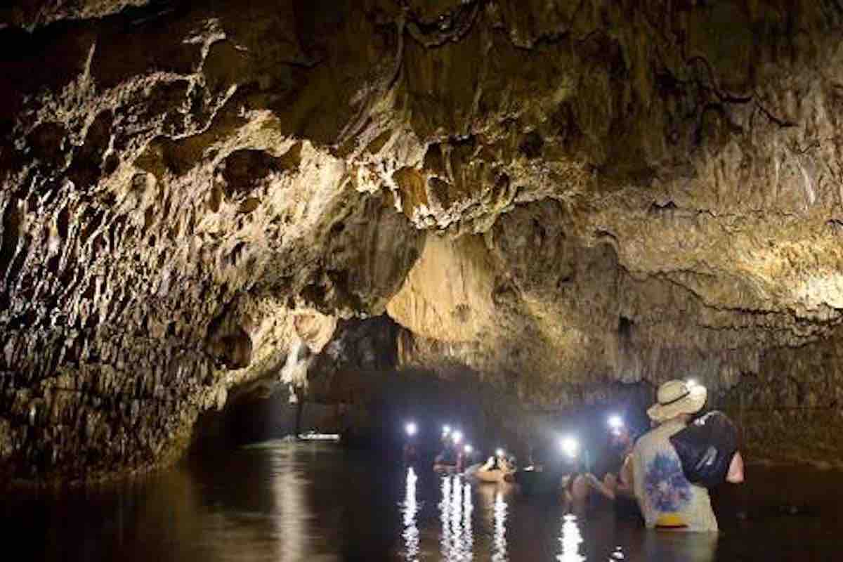Tour guests in bocas del toro bat cave with headlamps