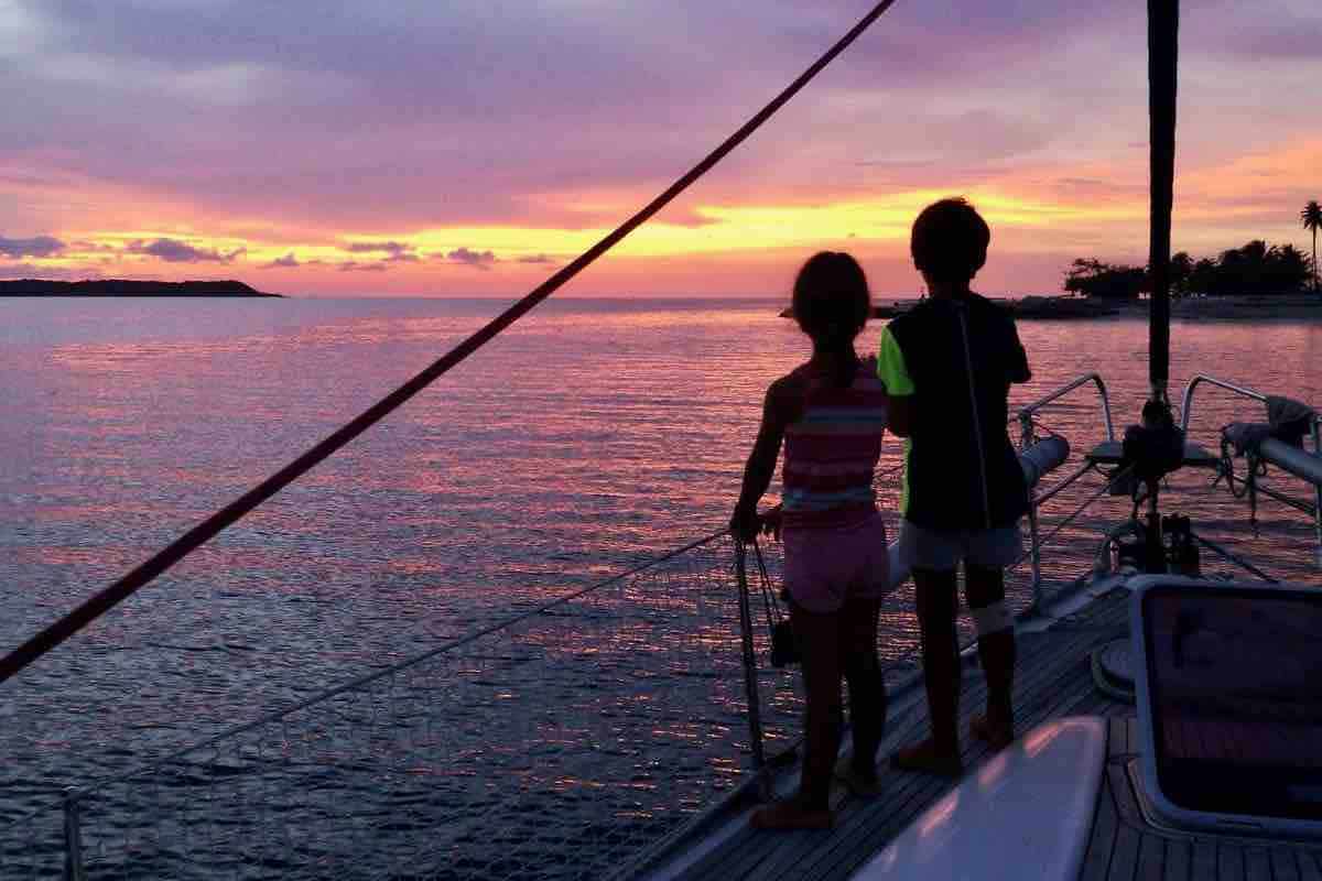Sailing Ferm sailboat kids watching sunset