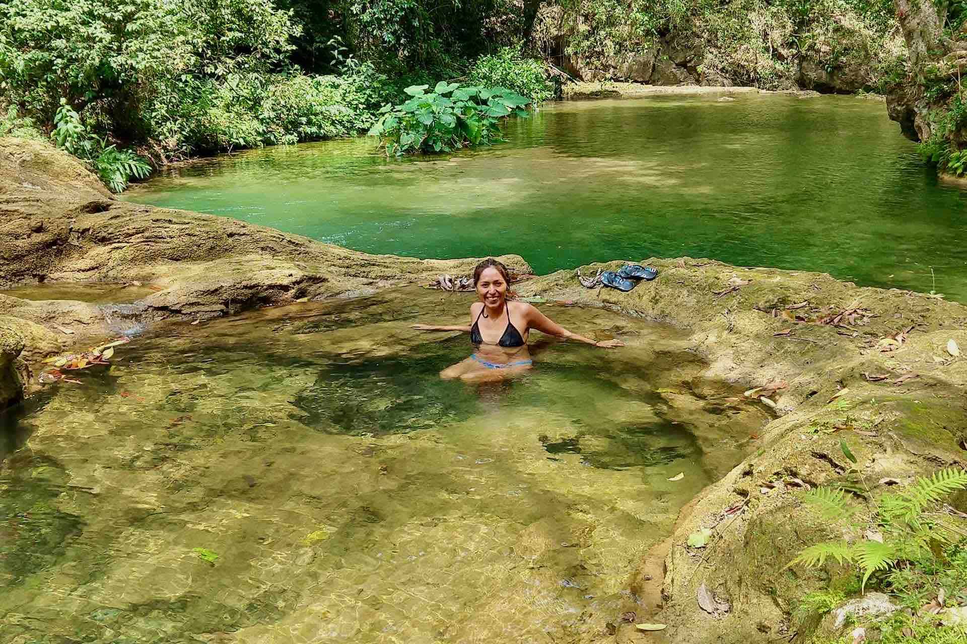 Huatulco waterfalls tour woman visitor in shallow river basin