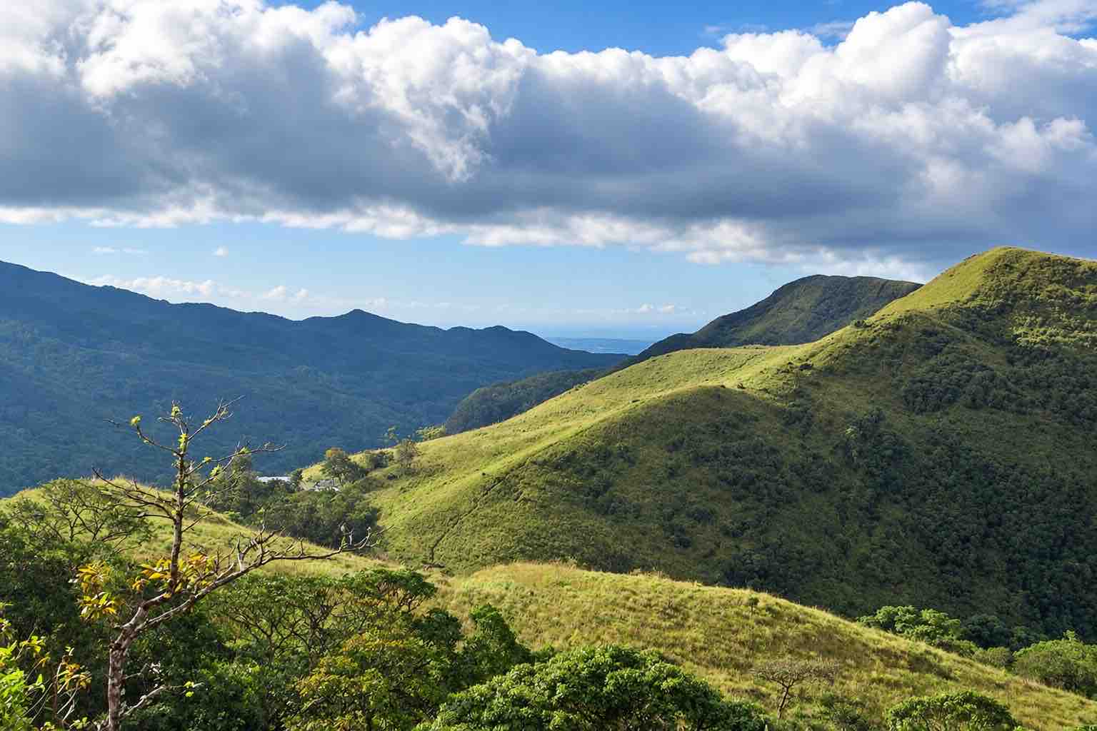 Sunlit grassy mountain slopes and distant ridges near El Valle de Anton