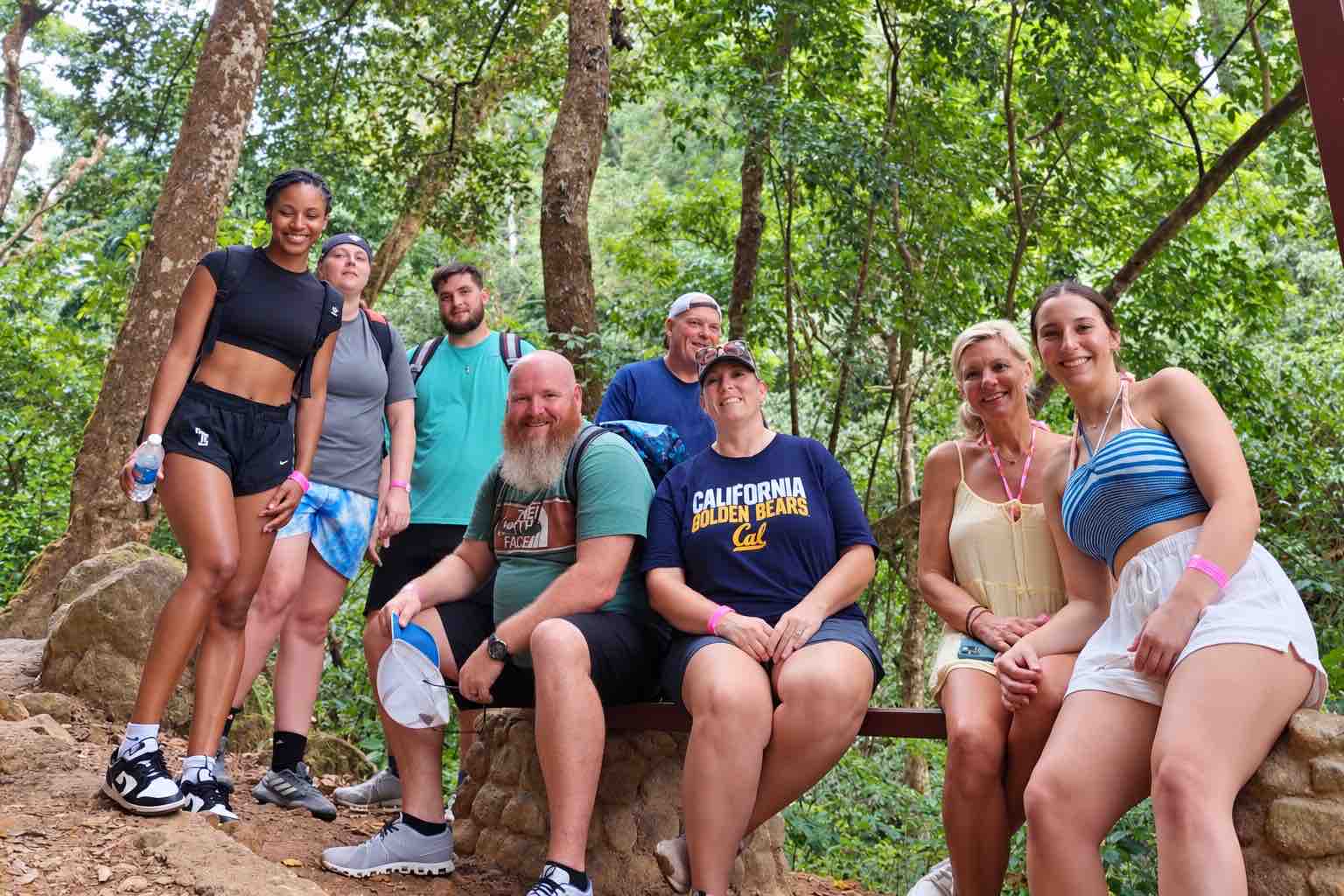 Hiking group taking a break among trees in Anton Valley