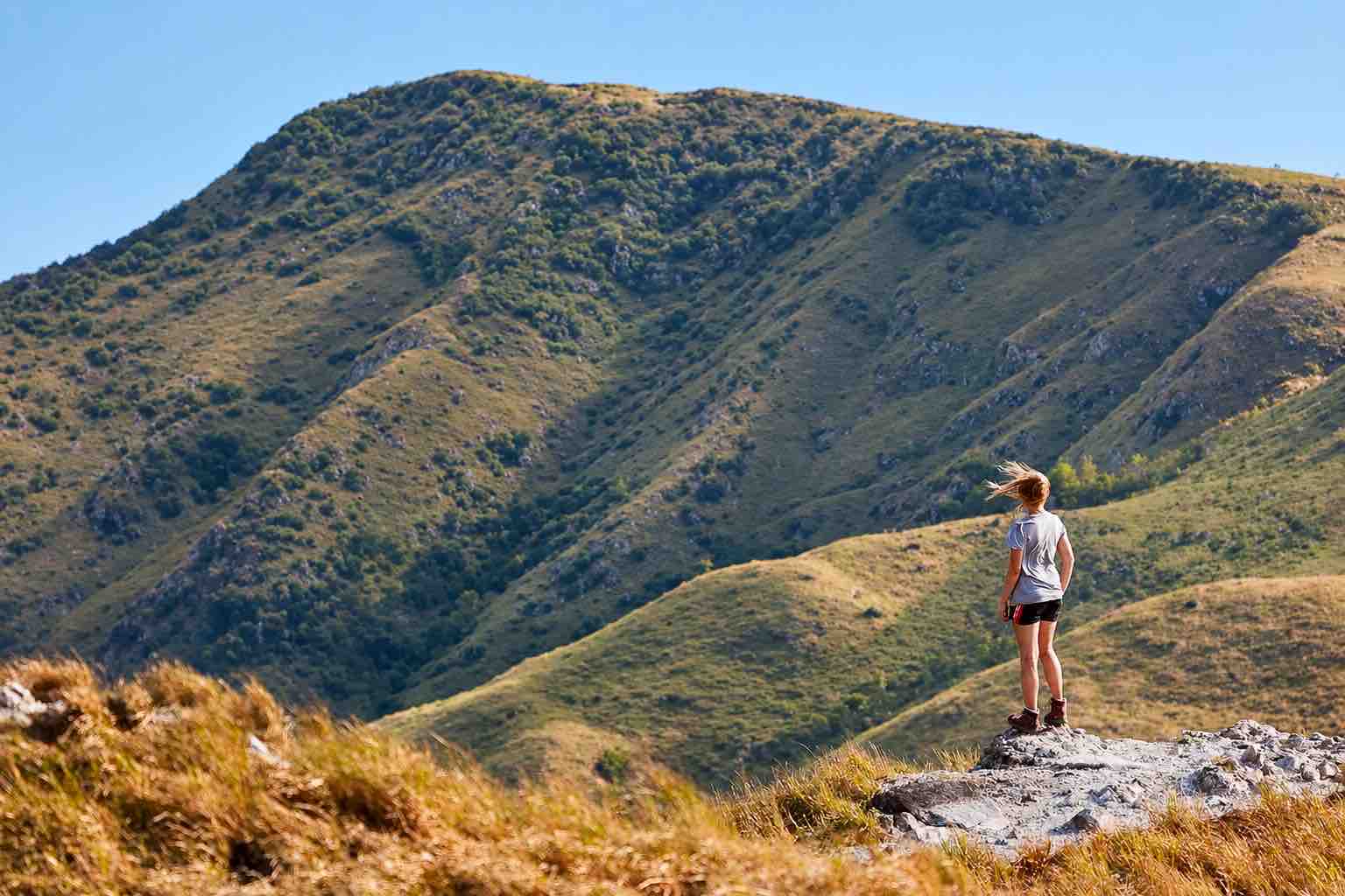 Anton Valley Tour – La India Dormida Viewpoint Hiker standing on a rocky viewpoint along La India Dormida