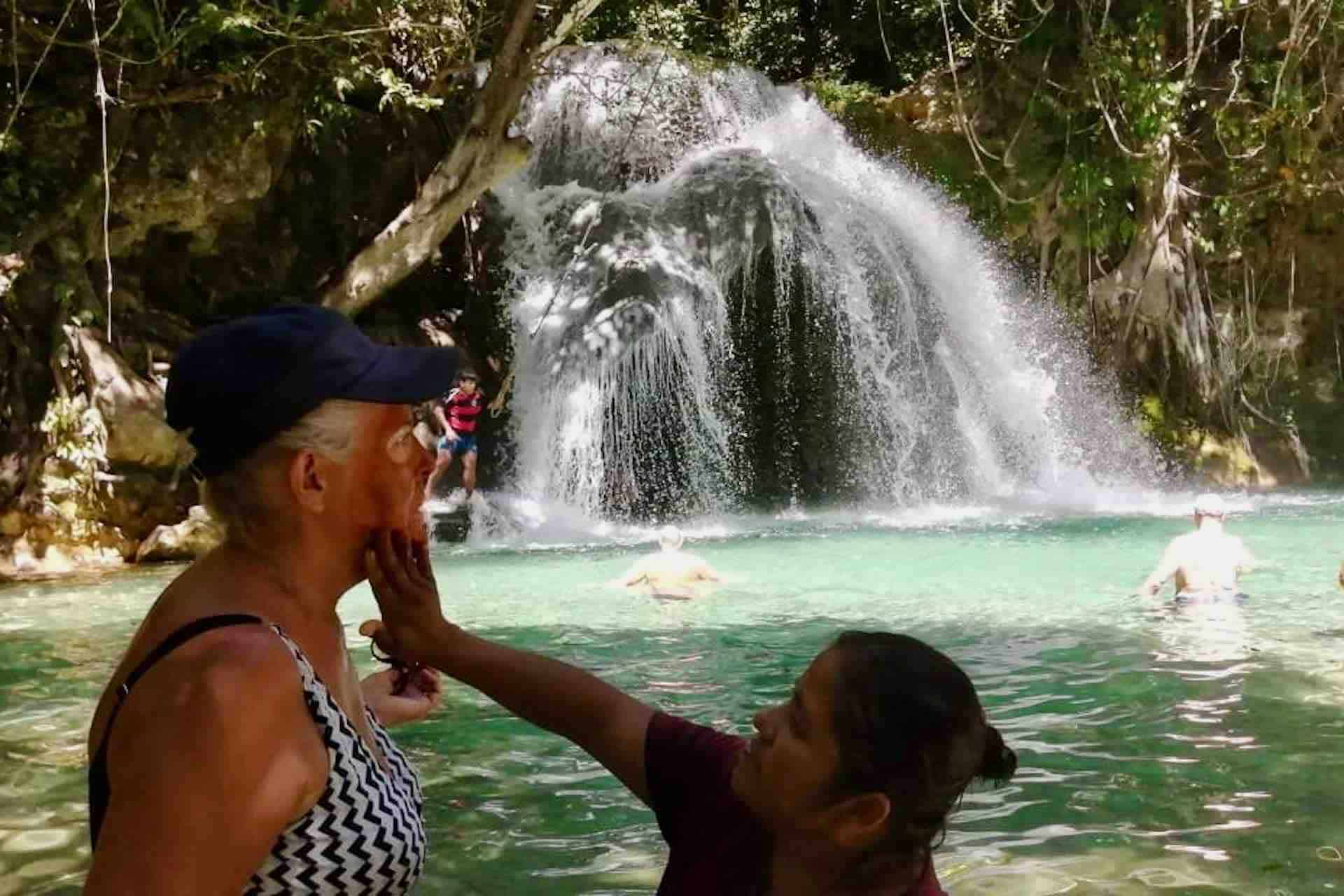 Huatulco waterfalls tour visitors entering water
