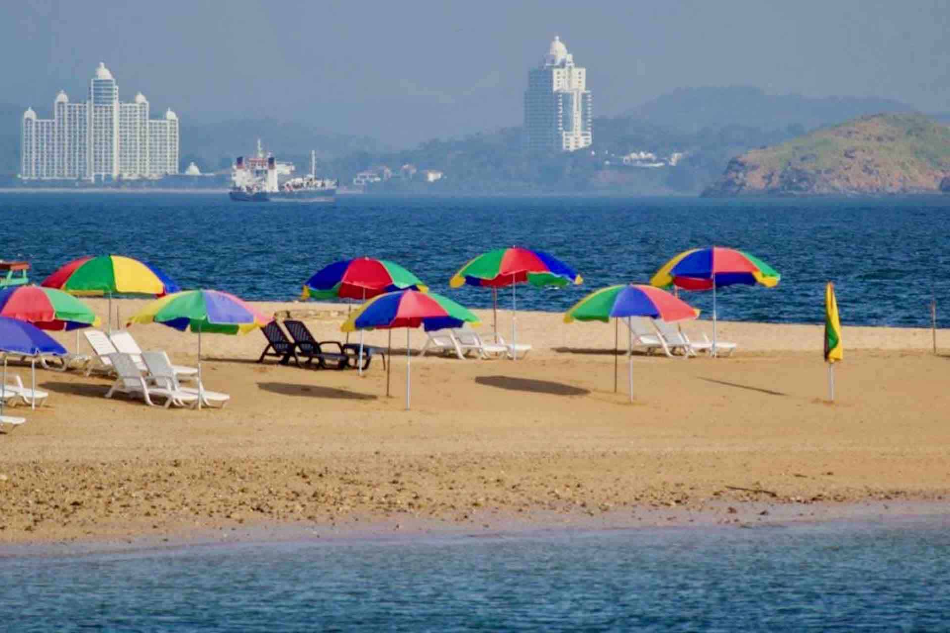 Taboga island Panama private sailboat tour beach with umbrellas