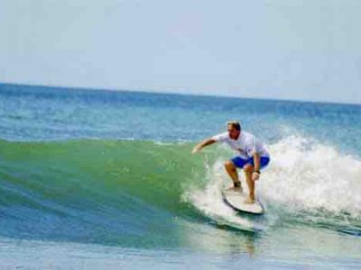 Surfer in white shirt on wave