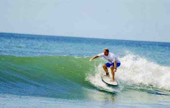 Surfer in white shirt on wave
