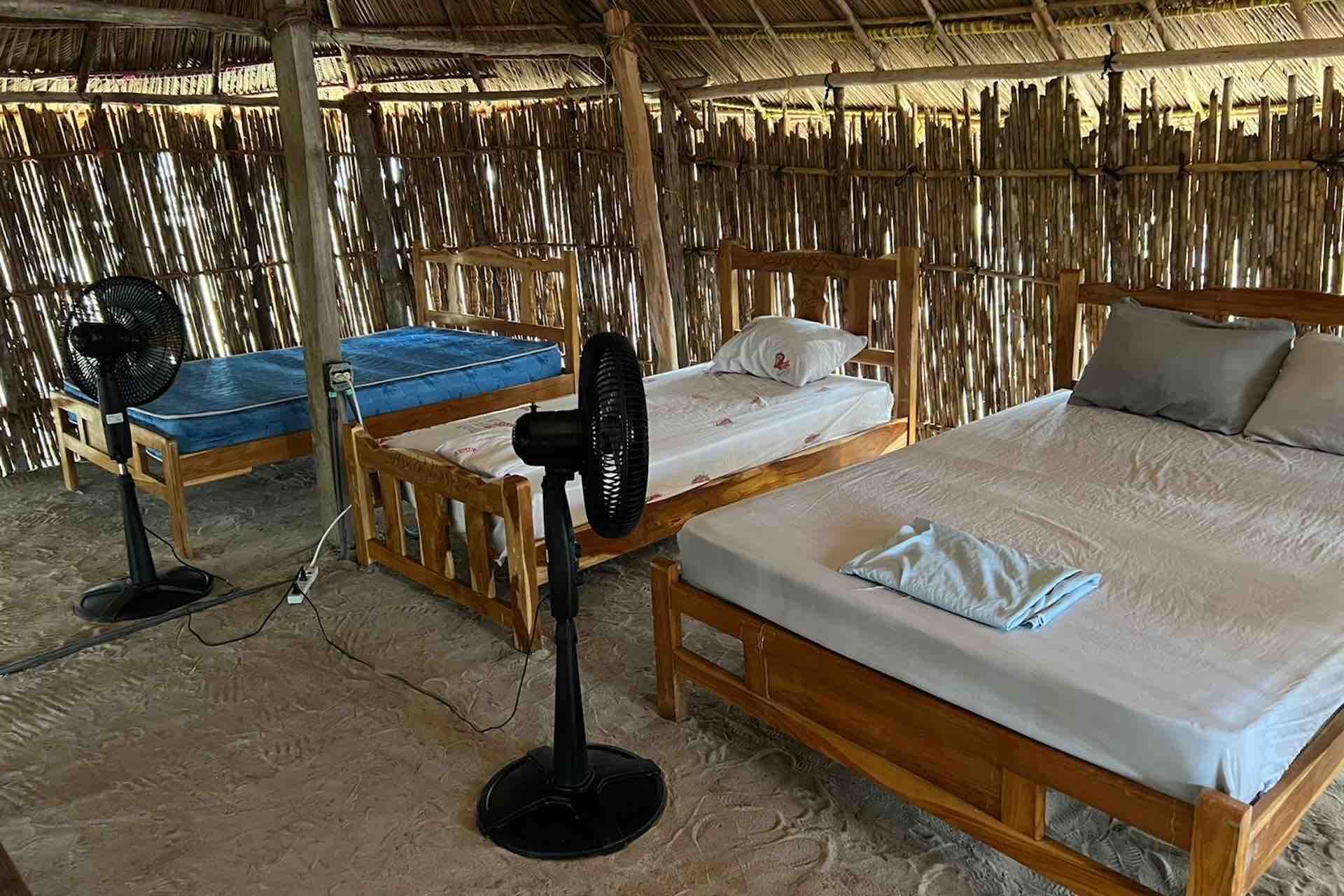 isla perro traditional hut san blas cabin Traditional private San Blas cabin on Isla Perro with sand floor and simple beds