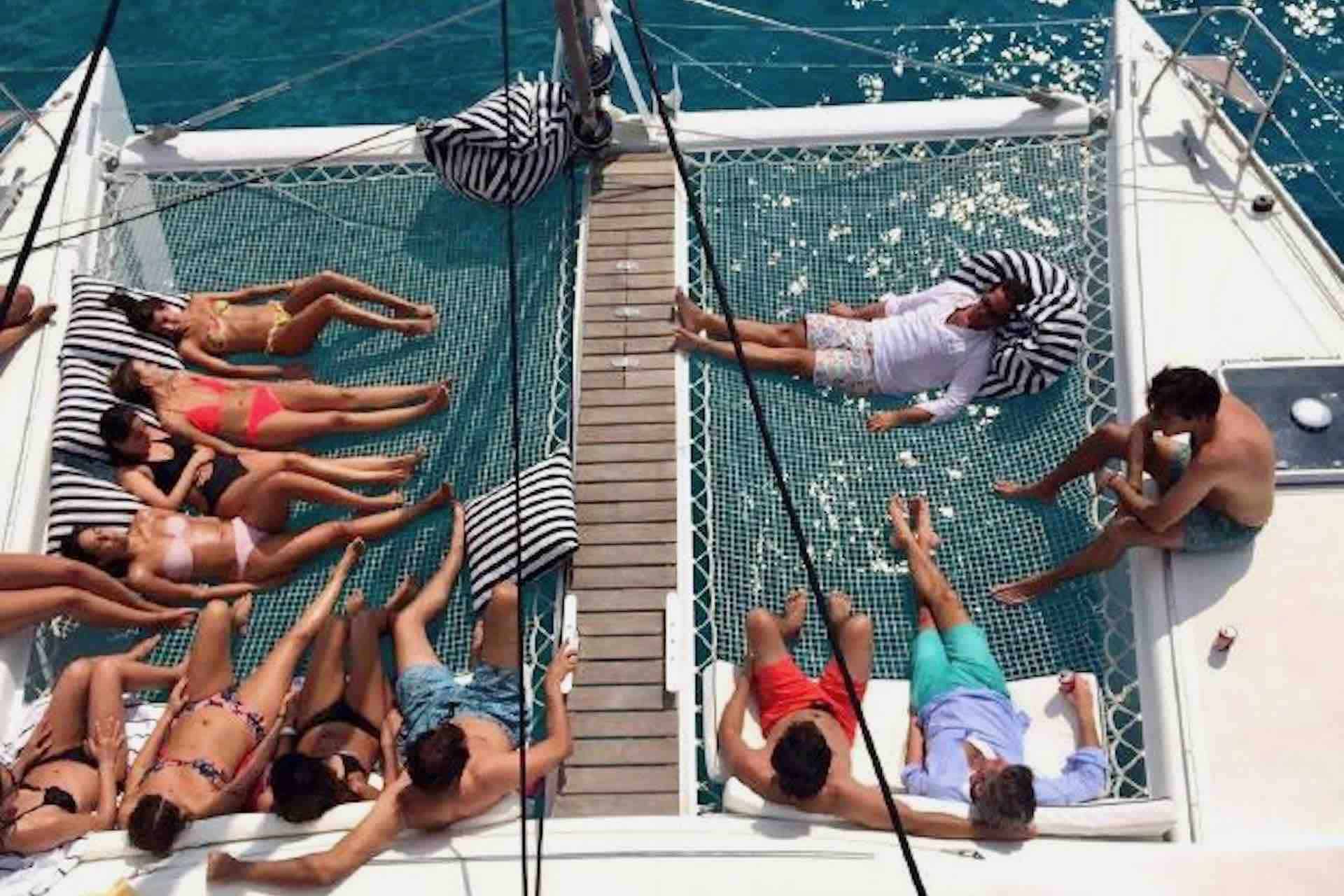 Faro San Blas catamaran charter guests on hammocks