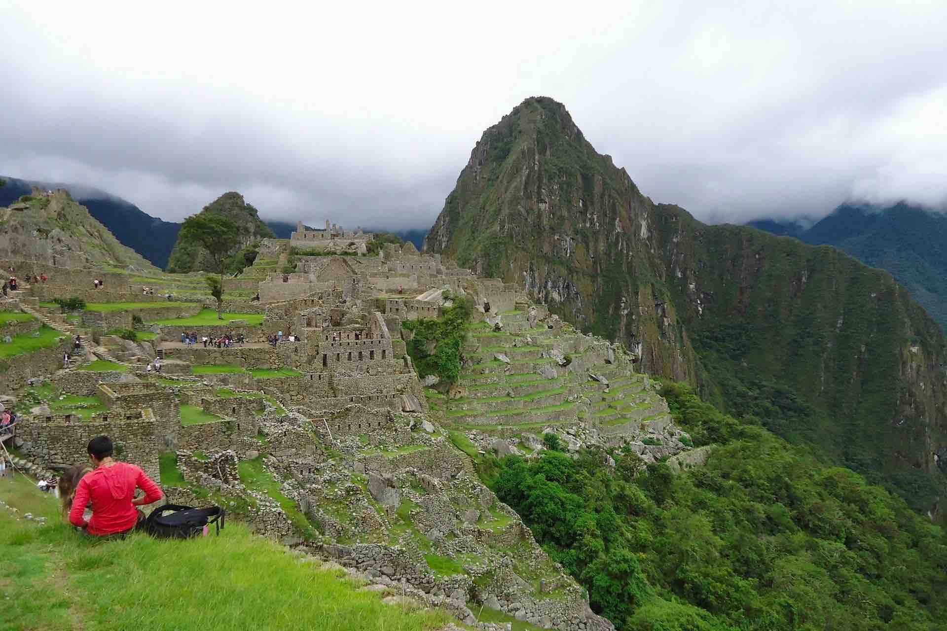 Machu Picchu ruins with woman