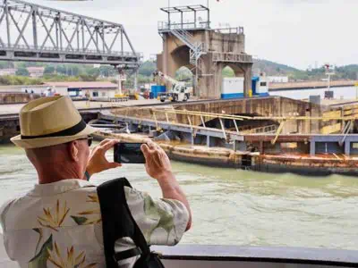 Pacific Queen Panama Canal Cruise in lock guest taking photo