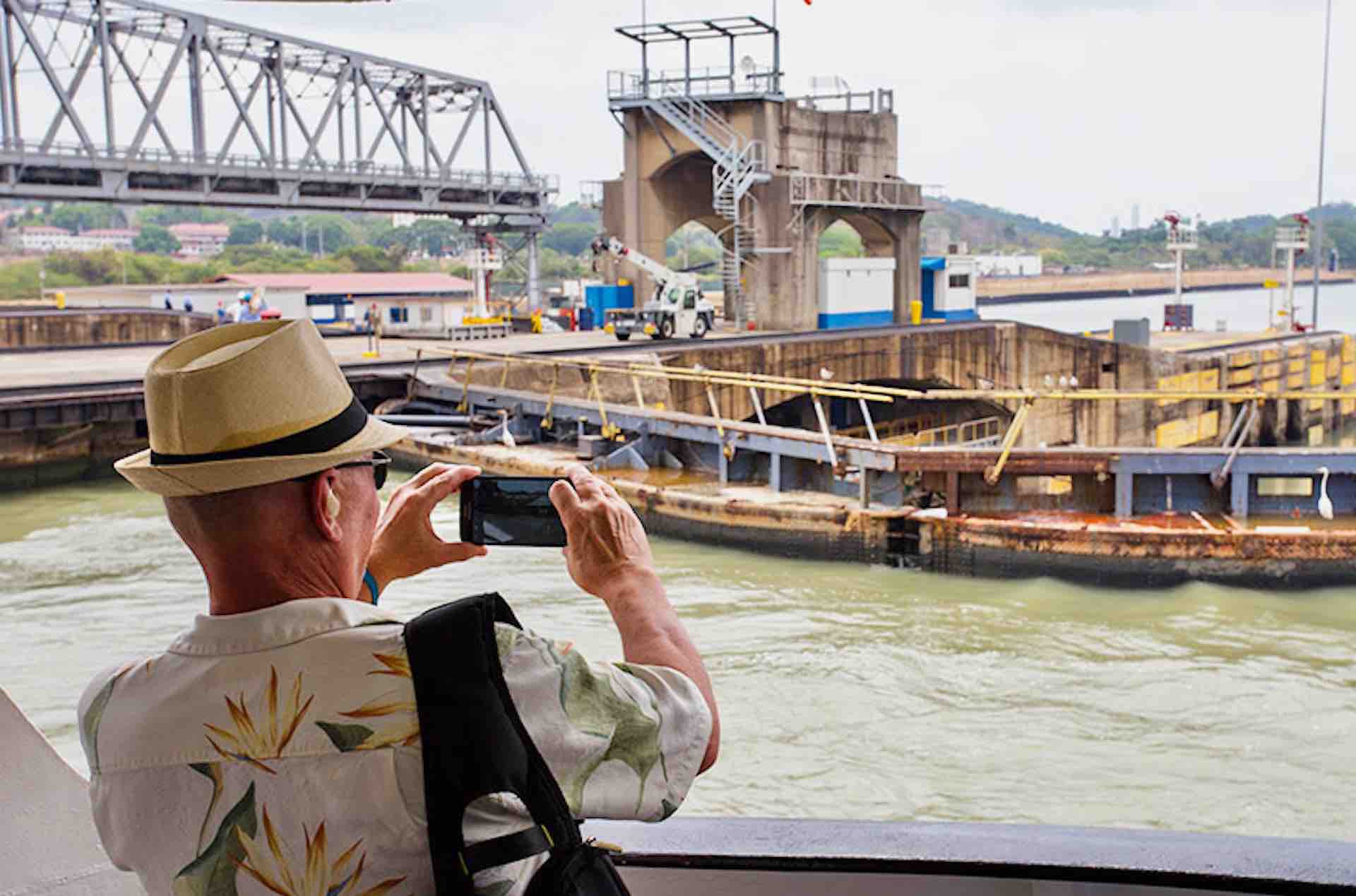 Pacific Queen Panama Canal Cruise in lock guest taking photo