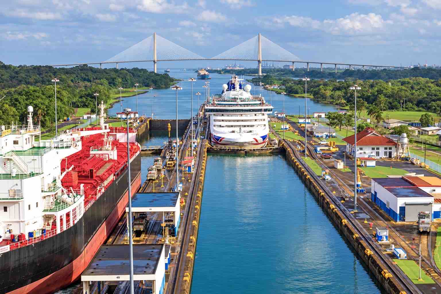 Panama Canal partial transit tour: a large cruise ship in a canal lock with a cargo ship in the adjacent chamber.