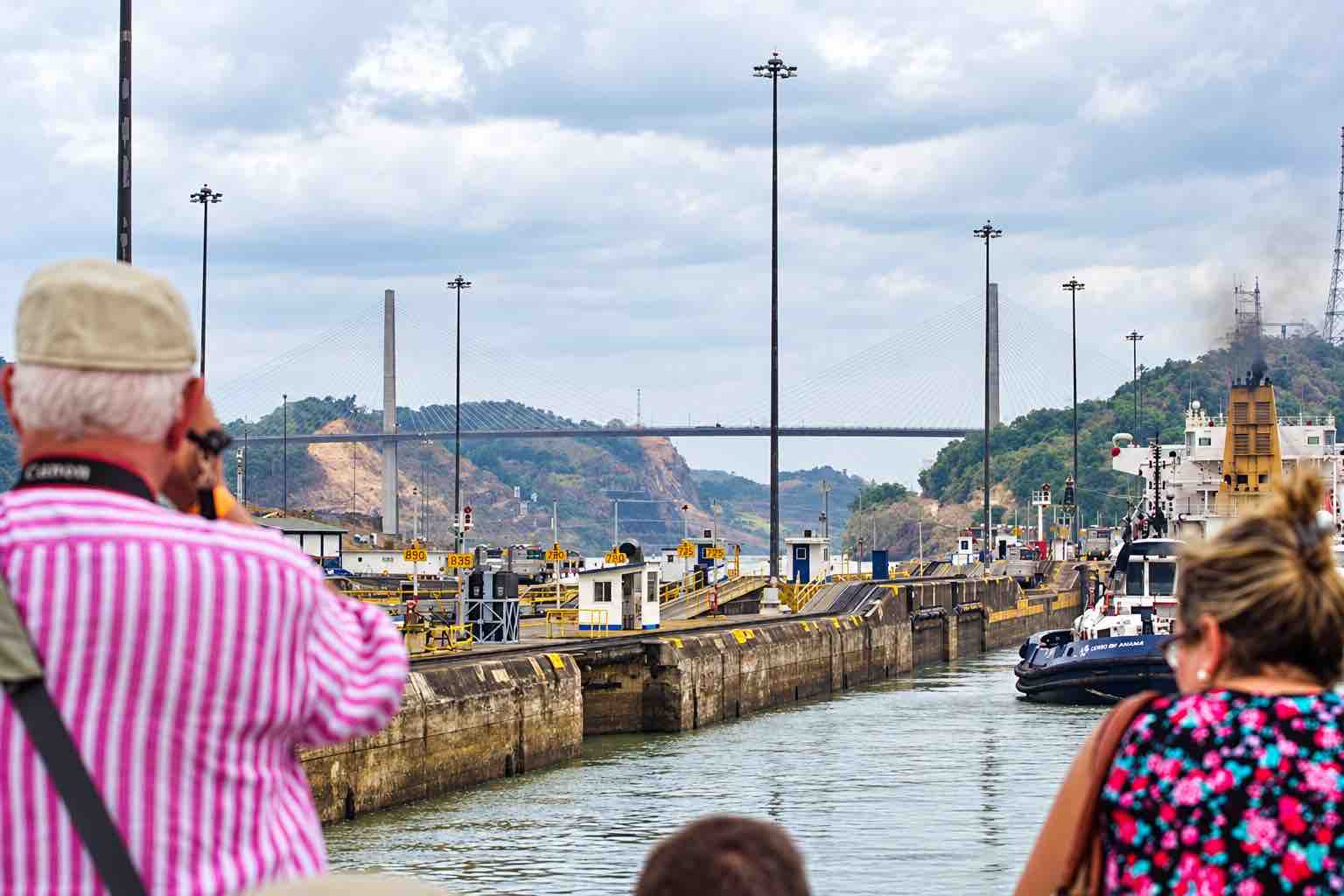 Panama Canal partial transit tour: cruise guests photographing the canal locks from the boat.
