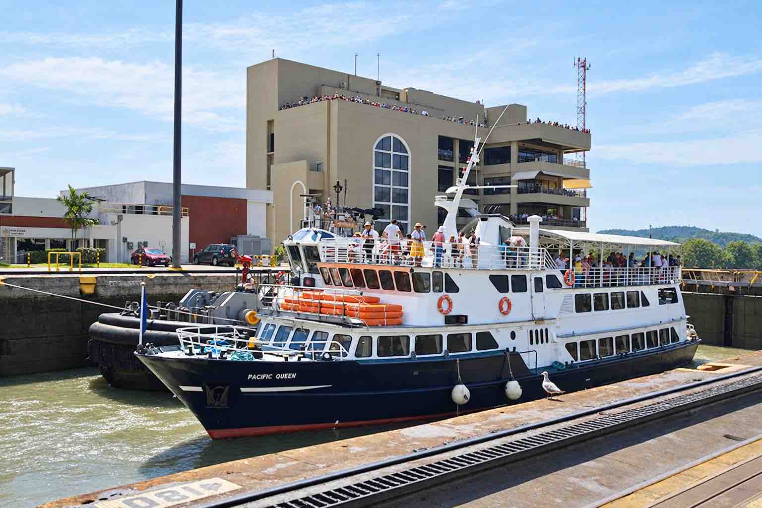 Panama Canal partial transit tour: pacific Queen boat beside the canal locks.